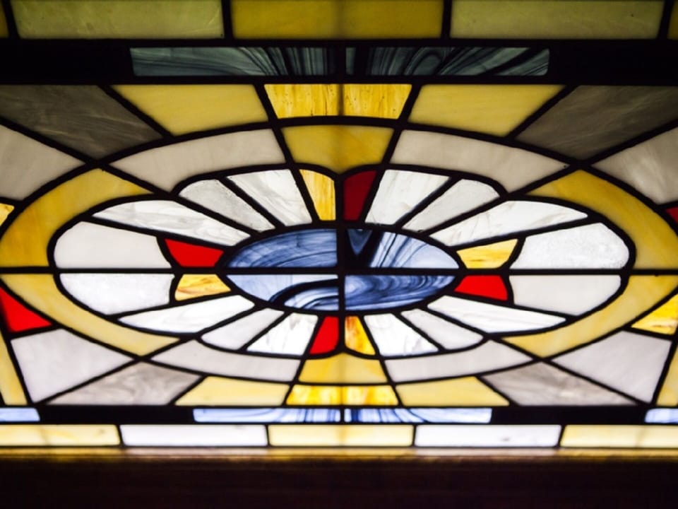 Stained glass panel above main bedroom bath.