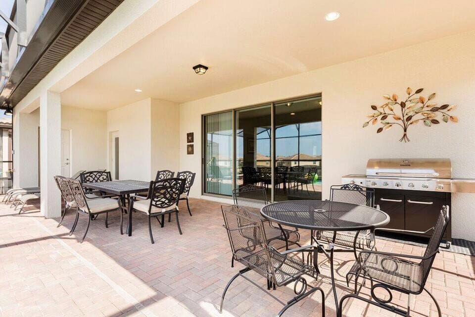 Patio table with chairs and BBQ gas grill.