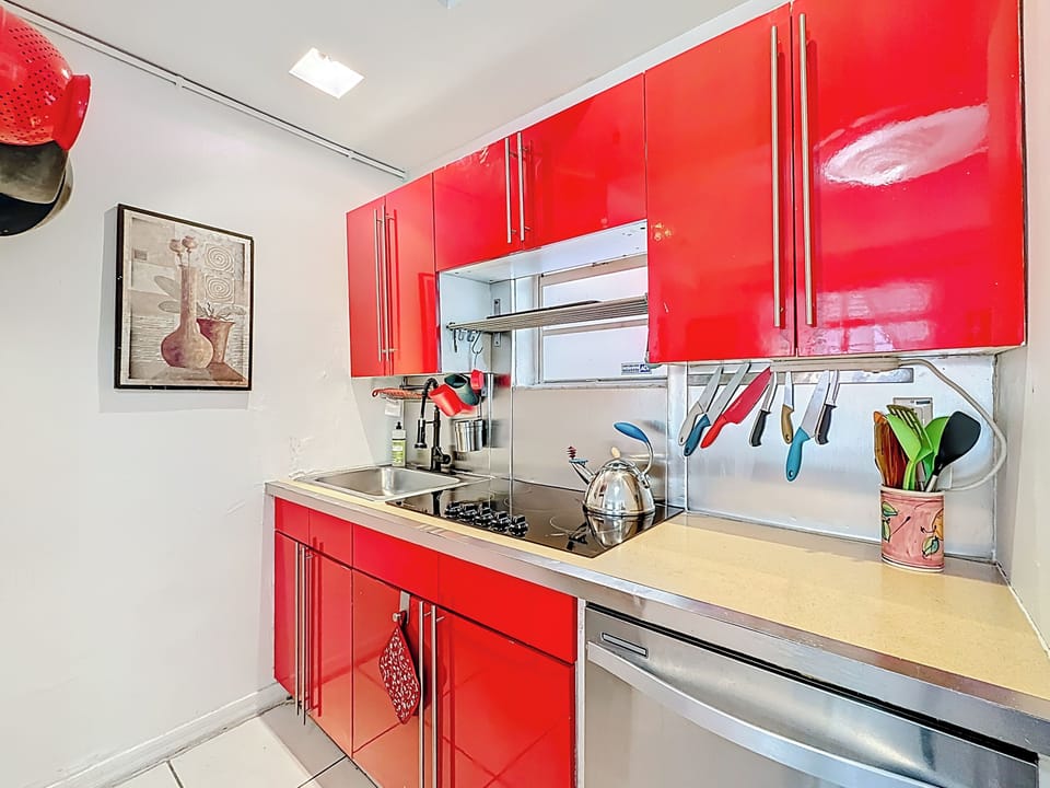 The red kitchen in our art deco 2 bedroom unit