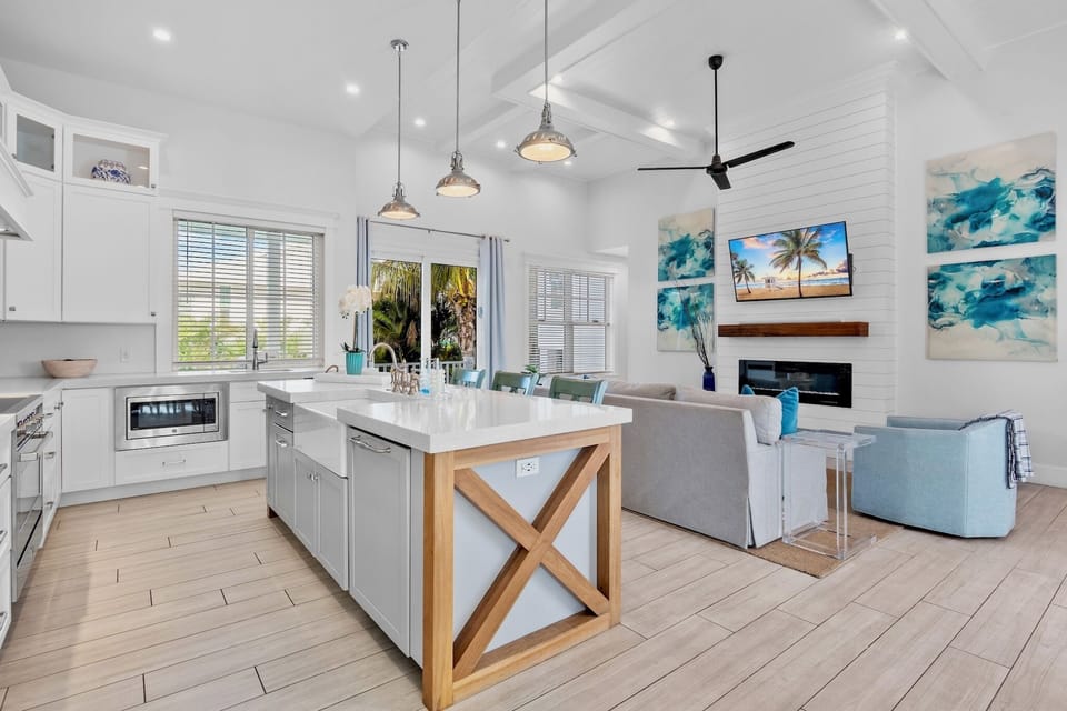 Gather around this spacious kitchen island where coastal vibes meet modern comfort—your perfect spot for morning coffee and evening conversations.