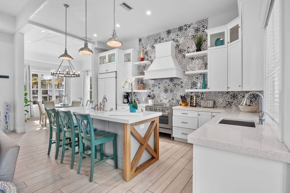 Your gourmet kitchen features stunning mosaic backsplash, spacious island with seating, and everything needed for memorable meal prep.
