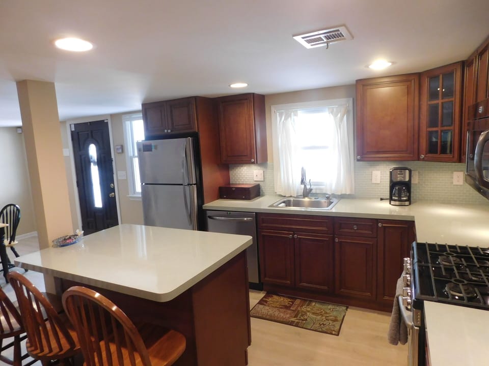 Seating for three at the movable kitchen island with power on the floor