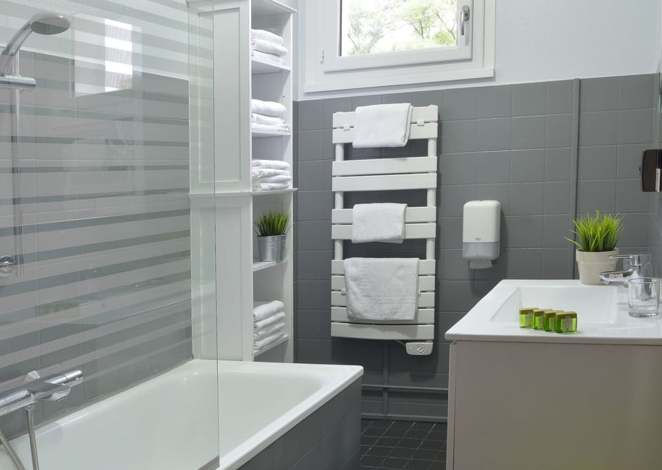 Superior Family Room | Bathroom | Hair dryer, towels, soap, shampoo