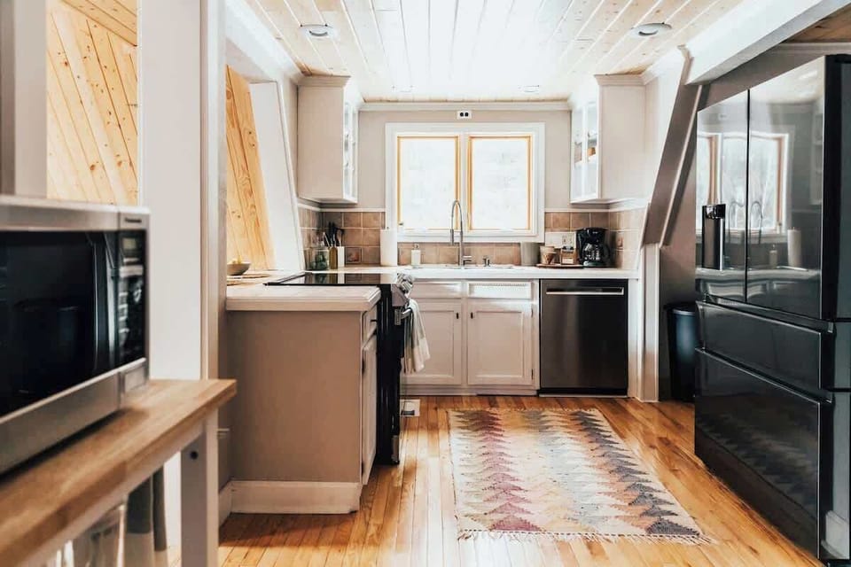 Full kitchen with new appliances and a picturesque view from the sink