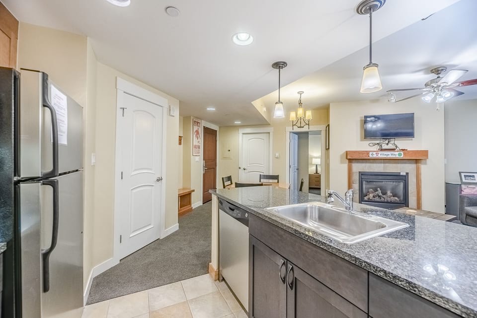 Kitchen - Granite counters, stainless steel appliances, pendant lighting, and a variety of kitchen utensils.