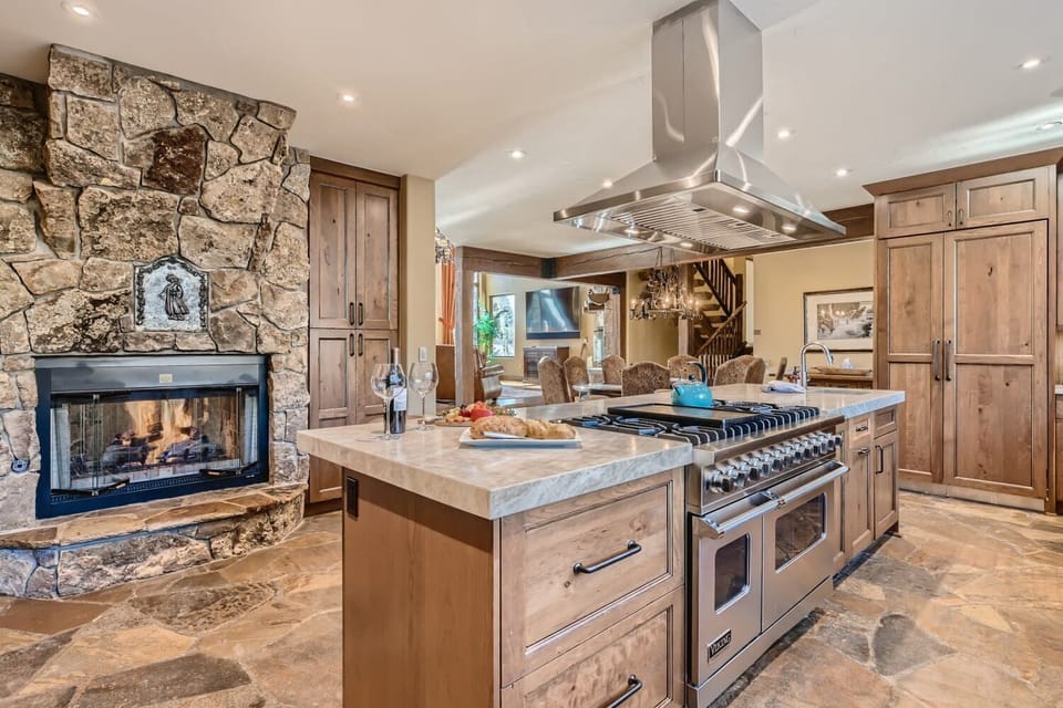 Viking range and double sided fireplace in kitchen