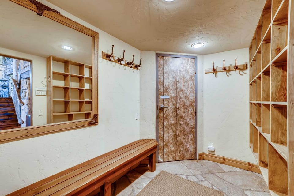 One of two mud rooms with ample ski storage