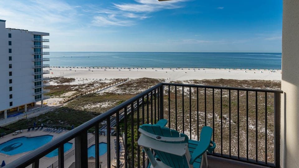 Balcony seating offers a serene view of the beach and gentle waves, perfect for relaxation and enjoying the coastal breeze