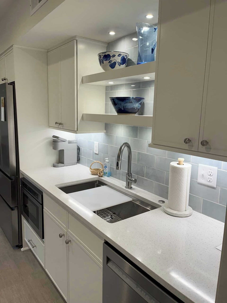 Bright, light kitchen with granite and workstation sink