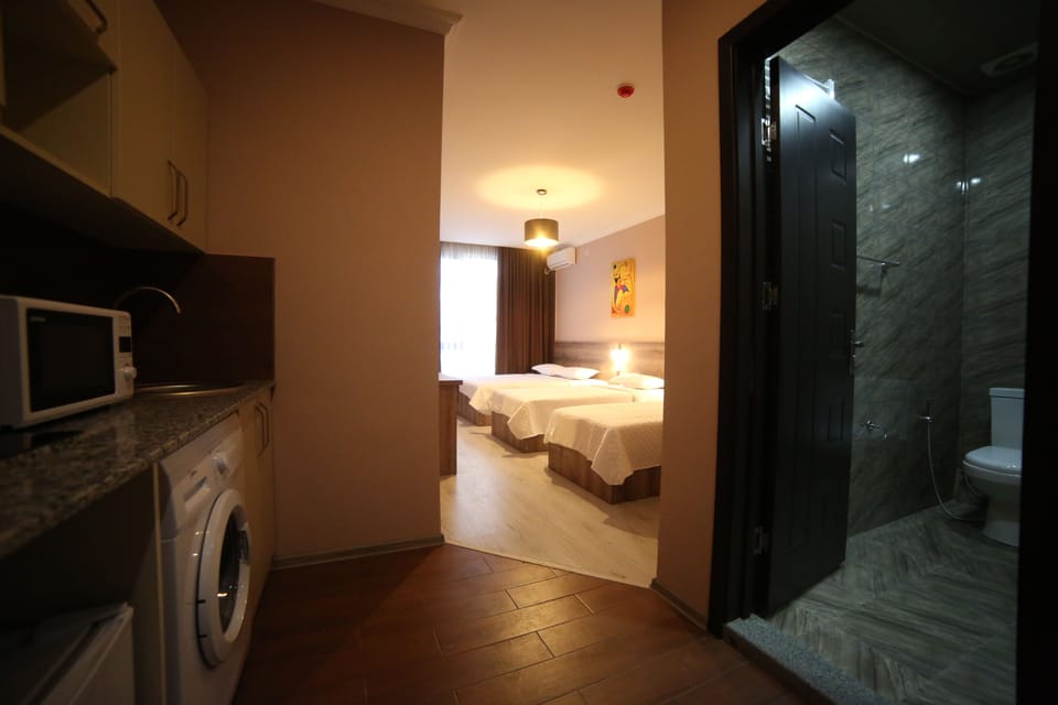 Family Quadruple Room, Multiple Beds | Living area | Flat-screen TV