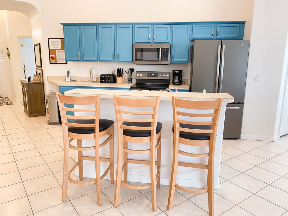 Bar stools at the kitchen counter provide additional seating