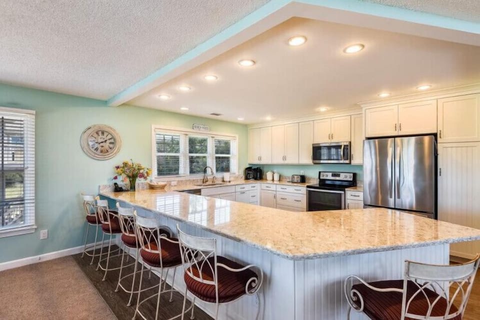 Gather around your spacious kitchen island with seating for everyone. Modern appliances and coastal colors set the stage for memorable meals together.
