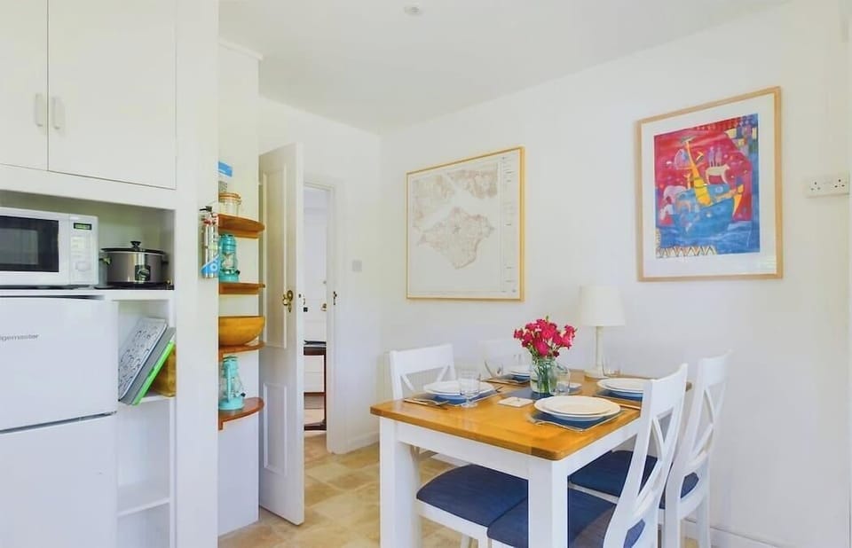 Dining table setup in the White Roses kitchen/dining space — great for meals and island breakfasts.
