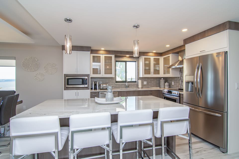 Kitchen with waterfall granite top, barstool seating. fully equipped kitchen