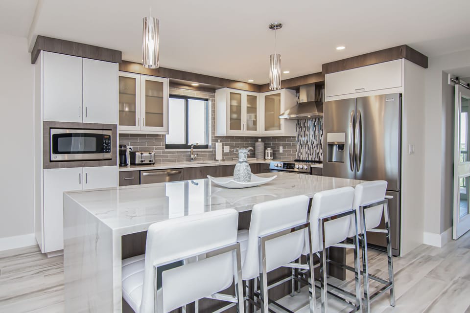 Kitchen with waterfall granite top, barstool seating. fully equipped kitchen