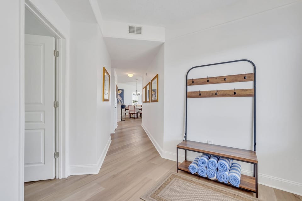 Entry foyer with two bedrooms and laundry machines to the left.