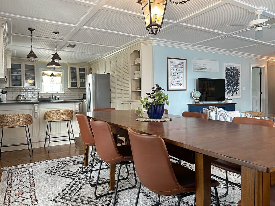 The dining room with a view of the kitchen & upstairs den