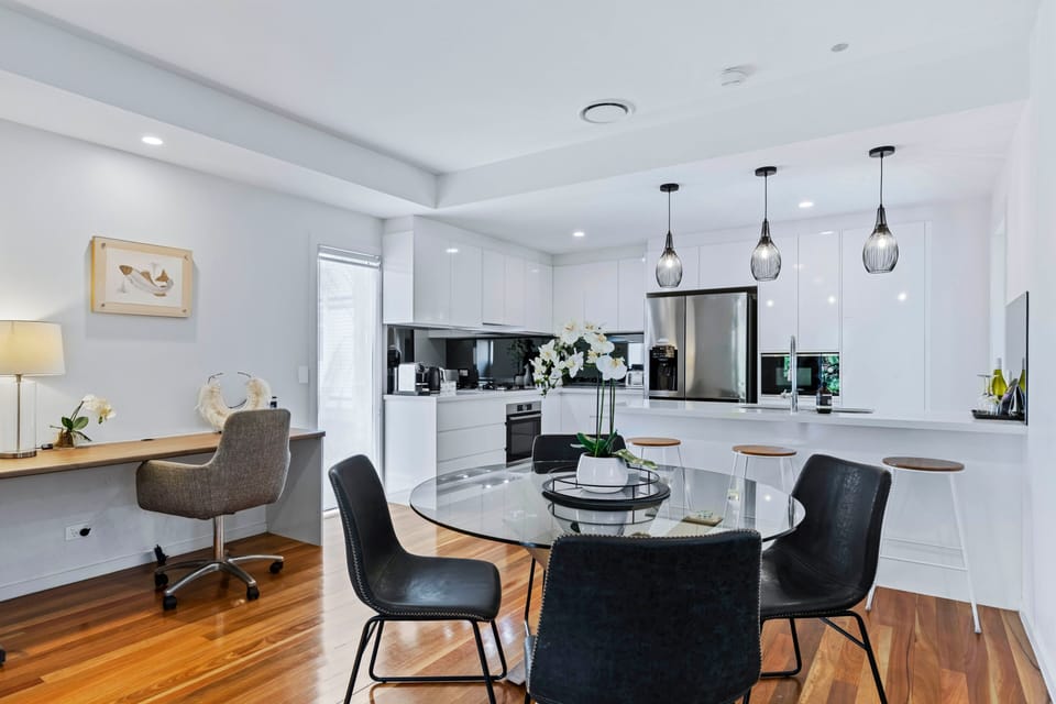 Dining for four beside the open kitchen at Park Ave Retreat.