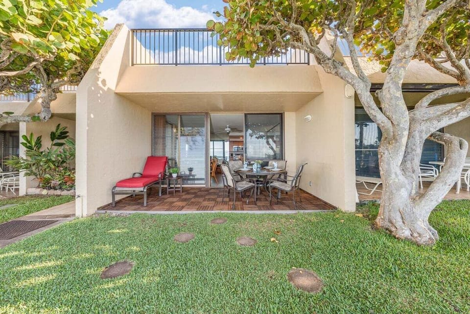 A peaceful garden patio with cozy outdoor seating, perfect for morning coffee or sunset relaxation