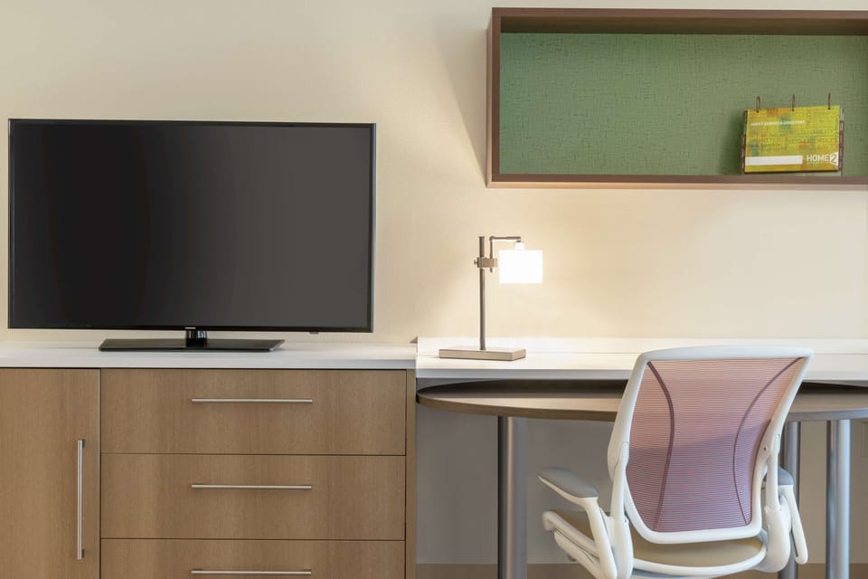 Desk, laptop workspace, blackout drapes, iron/ironing board