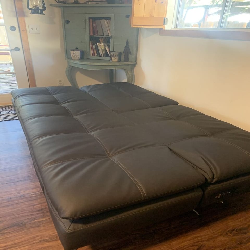 Futon, Full Size,  in Kitchen Area. Cell charging station on side of futon. 