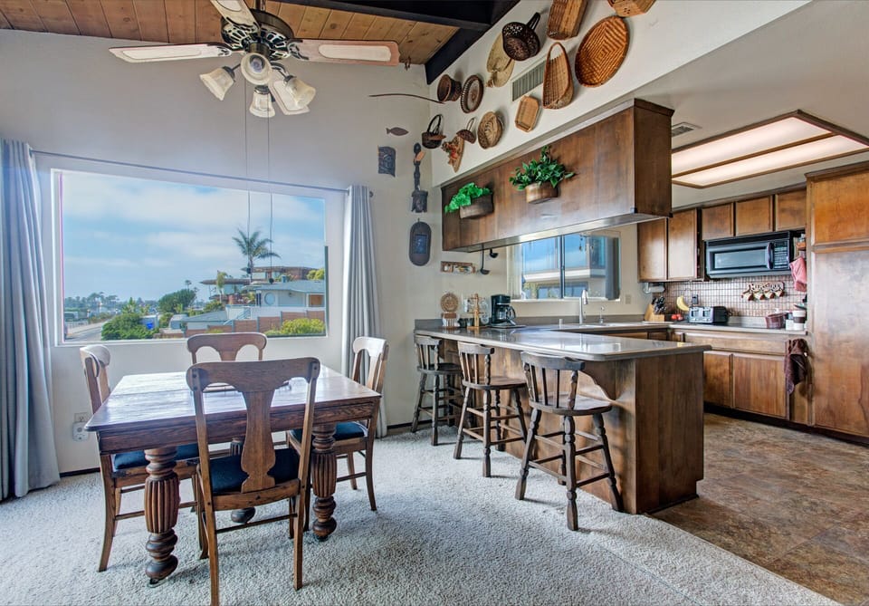 Dining area with wide windows and view of the ocean.