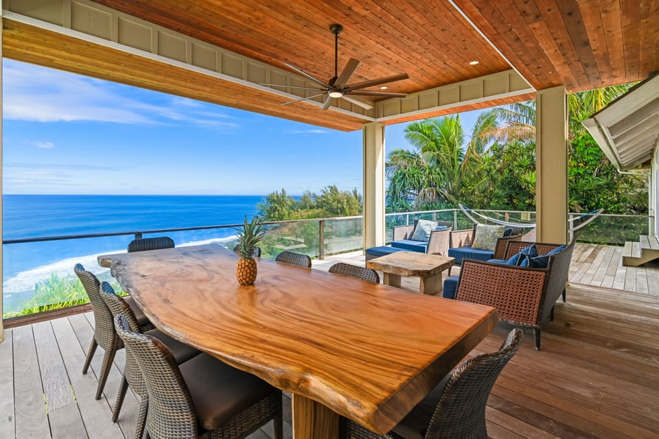 Impressive monkeypod wood dining table on deck