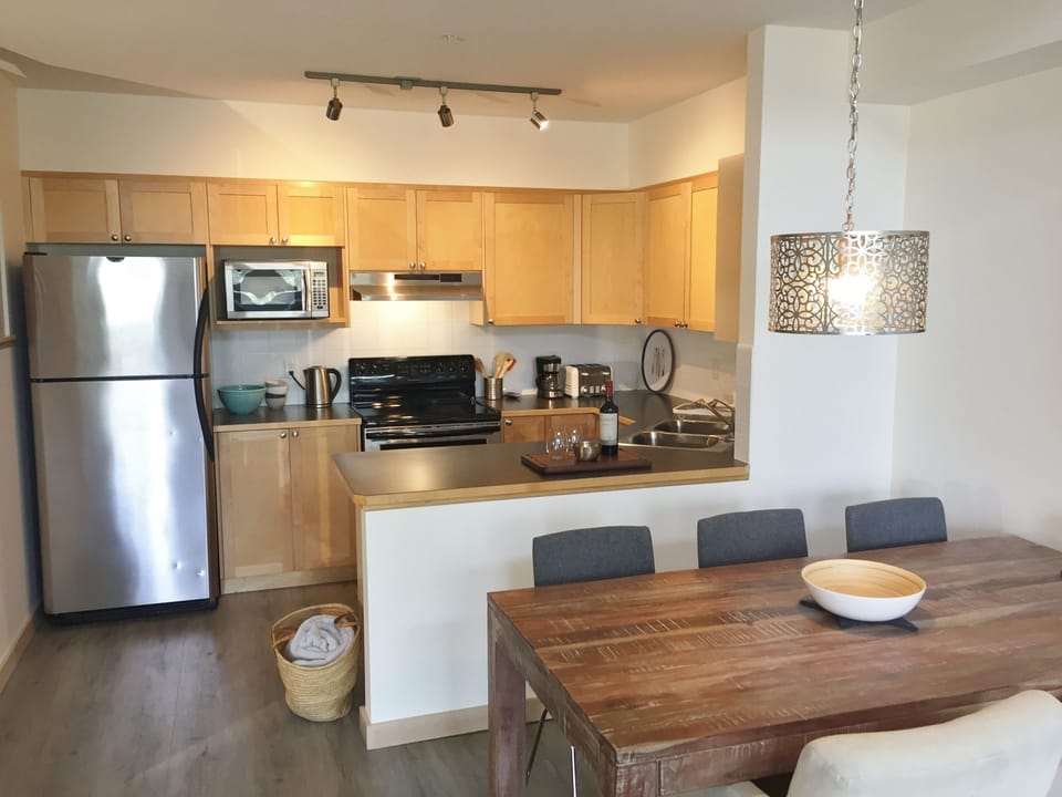 Open kitchen with stainless steel appliances.