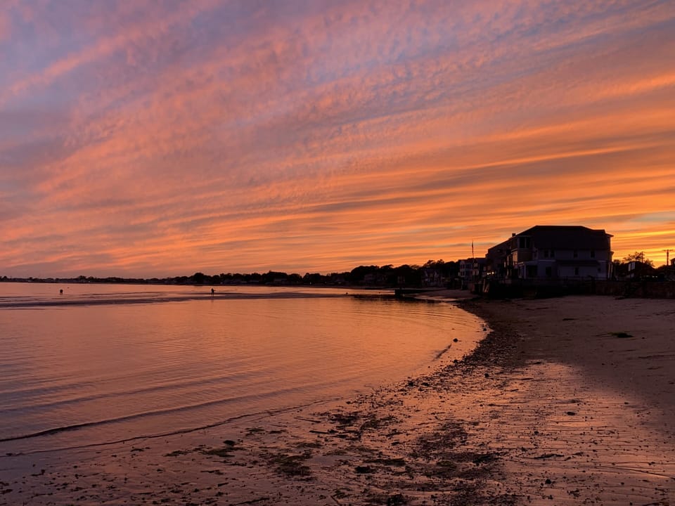 View of house from adjacent beach at sunset
