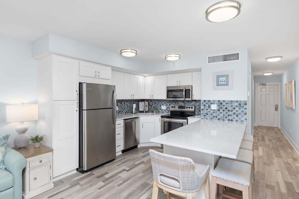 Fully equipped kitchen with brand new appliances and large island with breakfast bar style seating