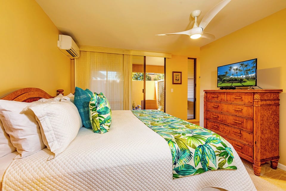 Flat Screen T.V. and ceiling fan in primary Bedroom