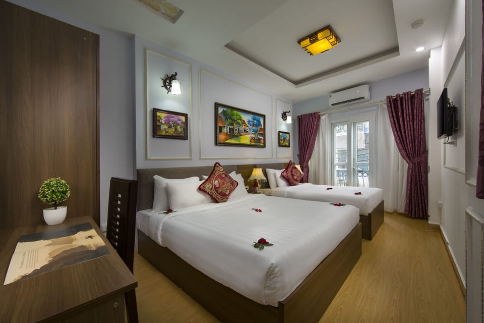 Deluxe Triple Room | Minibar, in-room safe, individually decorated, individually furnished