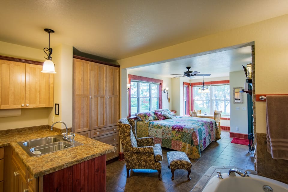 Looking from the Bathroom
This romantic getaway has it all. A full kitchen, king-size bed, wood burning fireplace, spa tub, and private patio looking at Lake Superior make Inn Suite #6 a must stay.