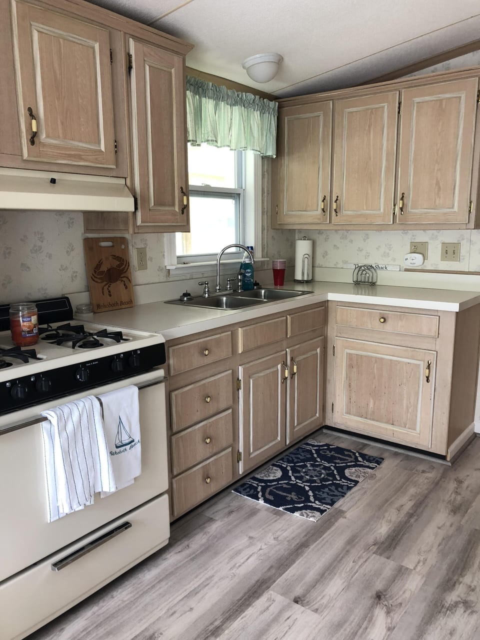 Kitchen with gas stove, refrigerator and microwave