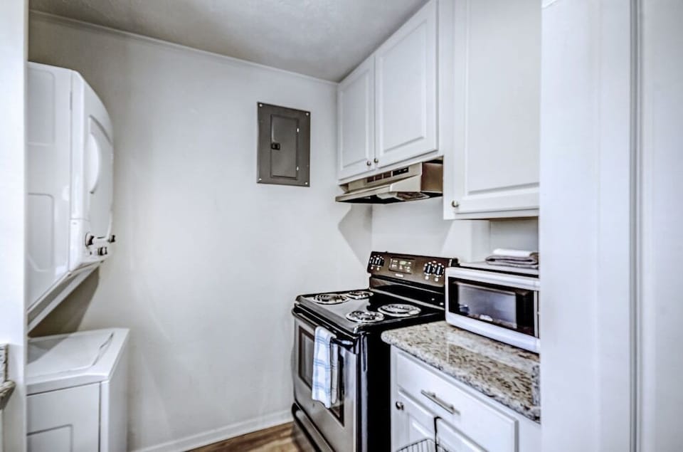 The stackable laundry is off of the kitchen. Perfect for a corporate stay.