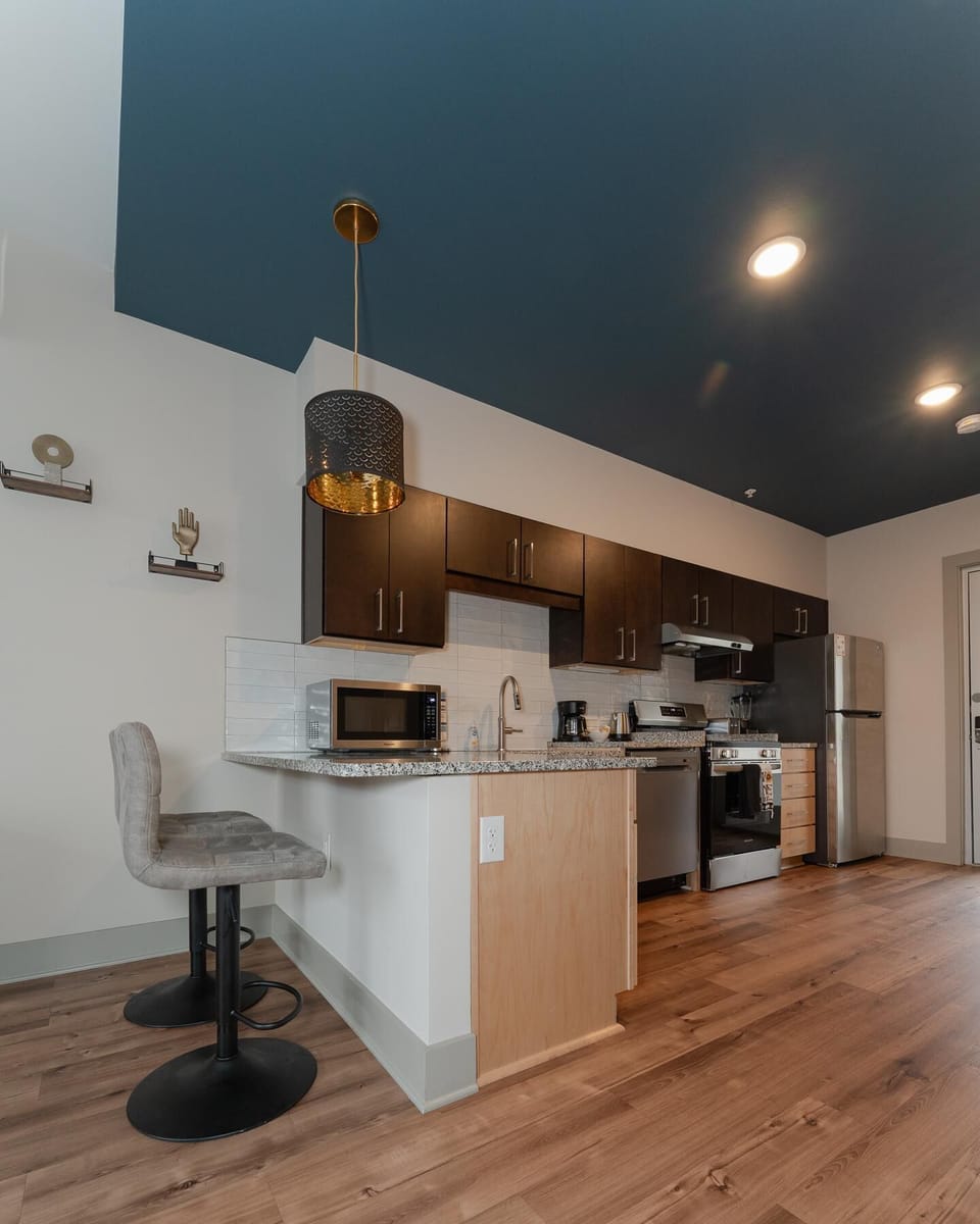 Modern kitchen with sleek appliances and cozy breakfast bar