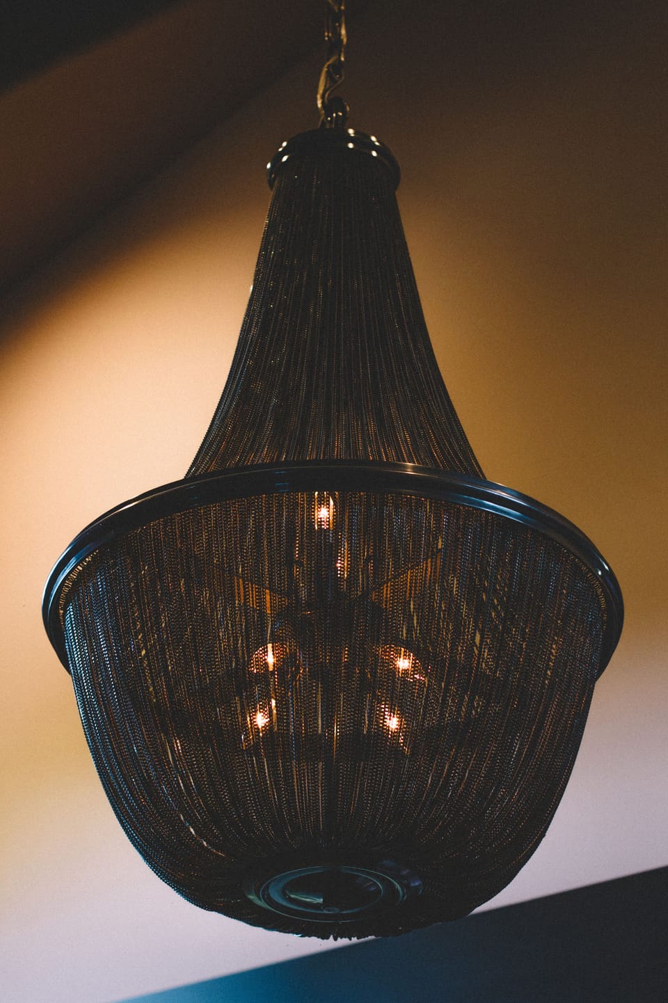 Metal chain chandelier- after dark casting a dramatic design throughout the loft
