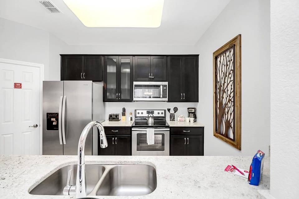 Where every culinary journey begins - our kitchen, complete with a sleek sink, is the heart of home and culinary adventures.