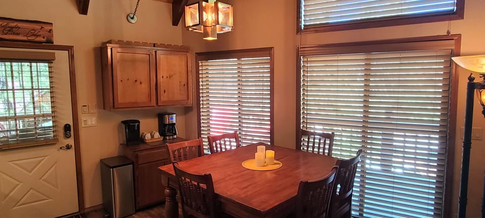 Table seats 8, pullout leaf. Keurig & Coffee pot. Games & cards underneath shelf