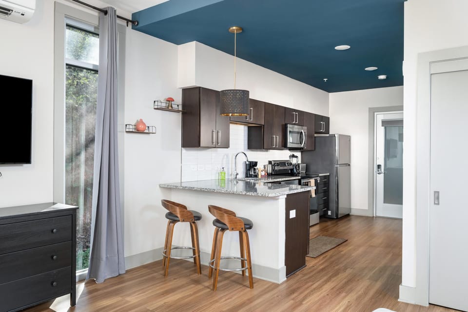 Modern kitchen with cozy breakfast bar and vibrant ceiling