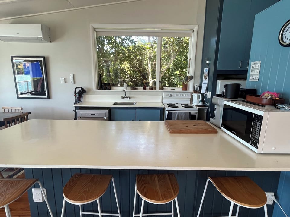 Kitchen and kitchen island with stools. Includes a large pantry