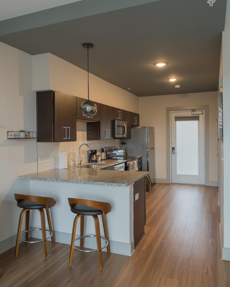 Modern kitchen with sleek appliances and cozy breakfast bar