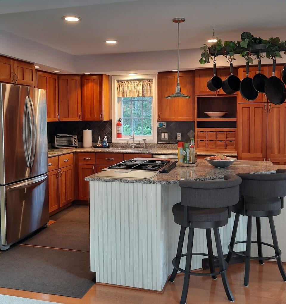 Seating at kitchen island.  Cook top with oven below.