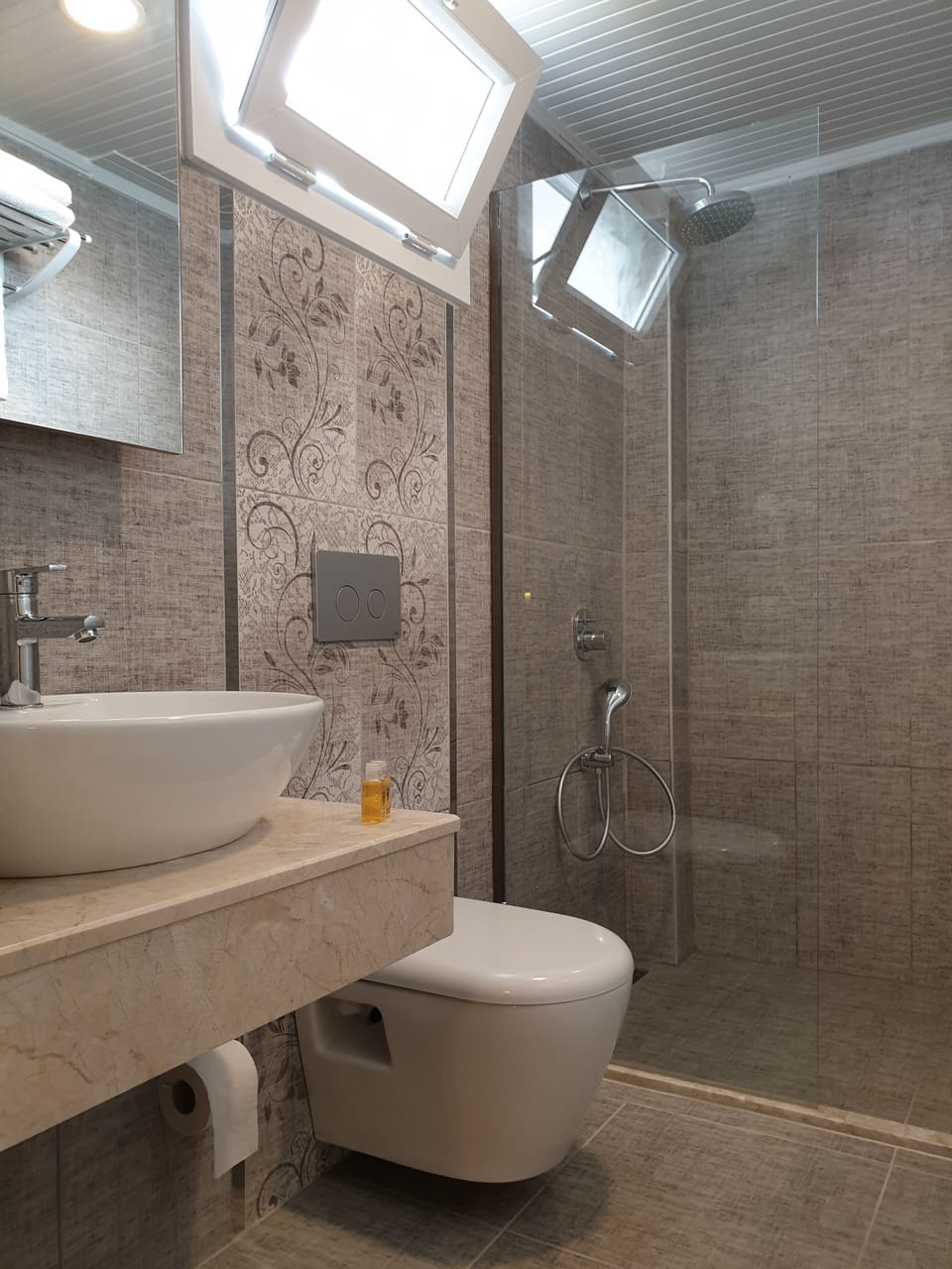 Shower, rainfall showerhead, hair dryer, towels