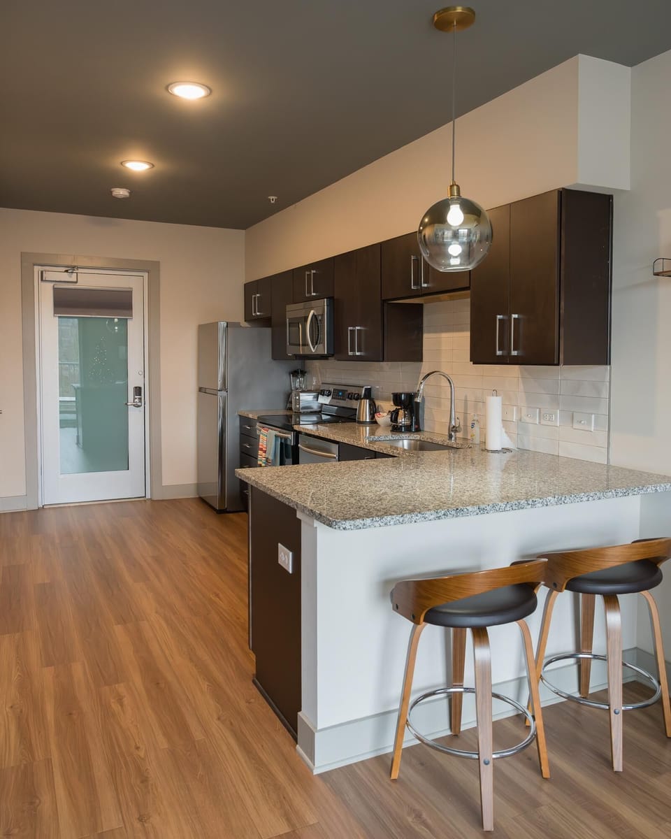 Modern kitchen with sleek cabinetry and breakfast bar seating