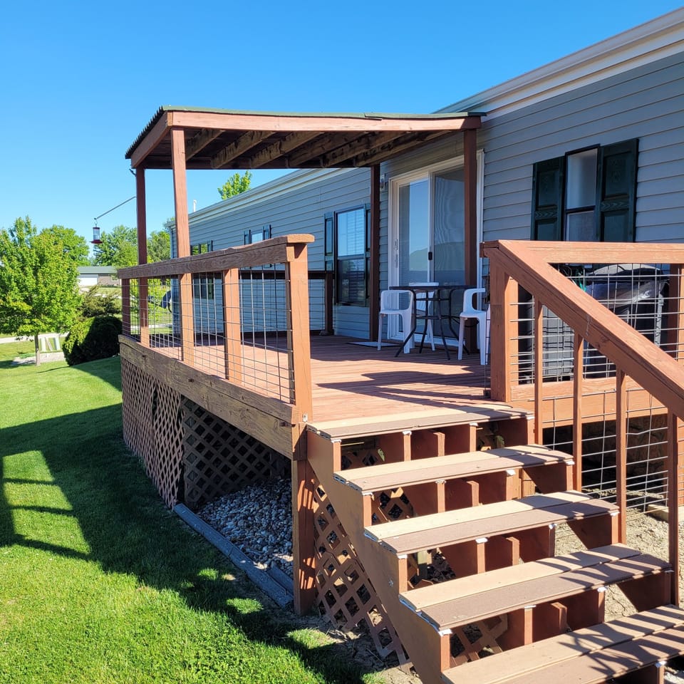 Front deck with a couple chairs to sit and relax. 