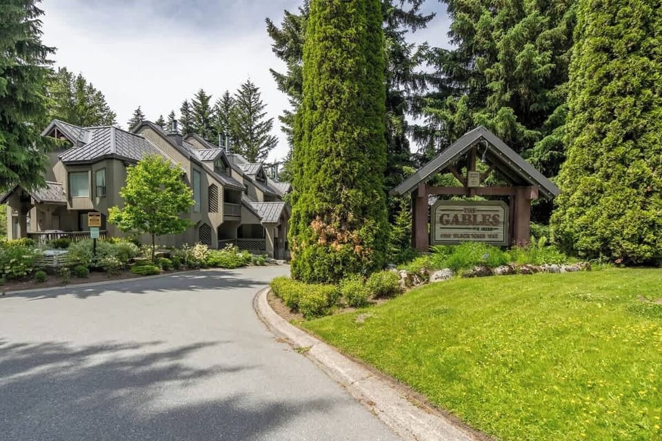 - Summer view of The Gables surrounded by lush greenery and trails  
- Peaceful Whistler location just minutes from lifts and village life  
- Perfect mountain retreat offering year-round outdoor access  