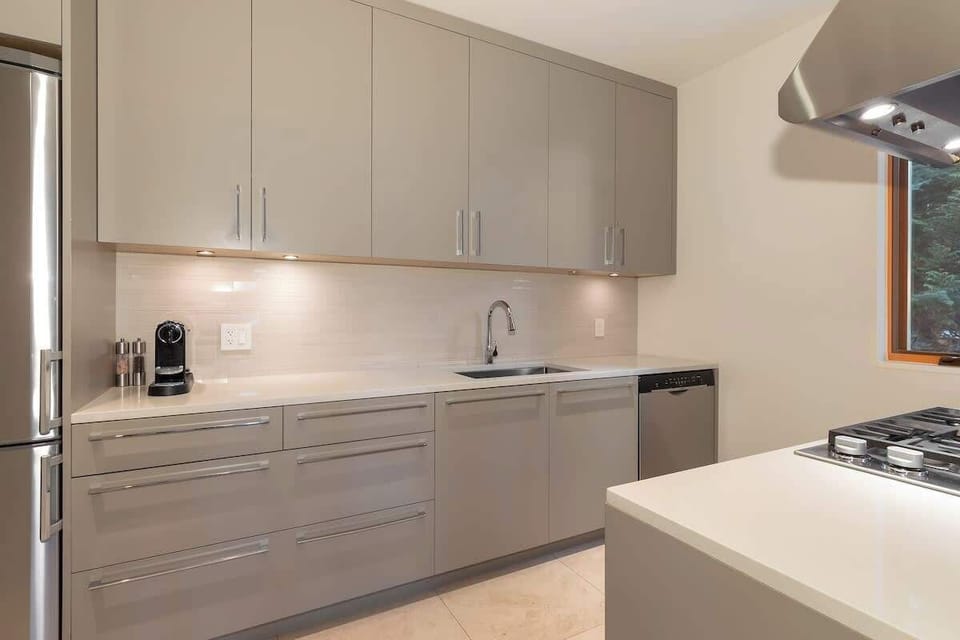 - Sleek secondary kitchen featuring soft gray cabinetry and modern lighting  
- Fully equipped with stainless steel appliances and espresso maker  
- Ideal prep space for hosting or family cooking convenience  