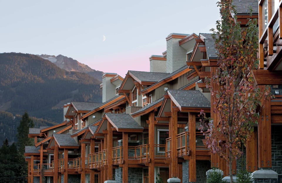 
- Scenic mountain townhomes framed by pine trees and twilight peaks - Architecture blends rustic wood tones with classic alpine design - Peaceful location ideal for morning coffee and evening stargazing