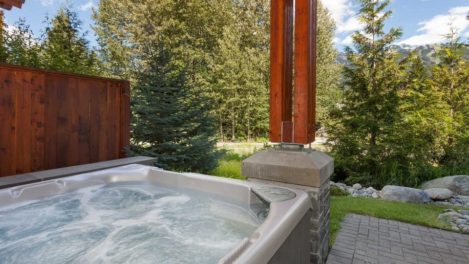 - Outdoor hot tub with bubbling jets and forest scenery  
- Relax under the open sky after skiing or hiking  
- Private mountain-view soak surrounded by nature  